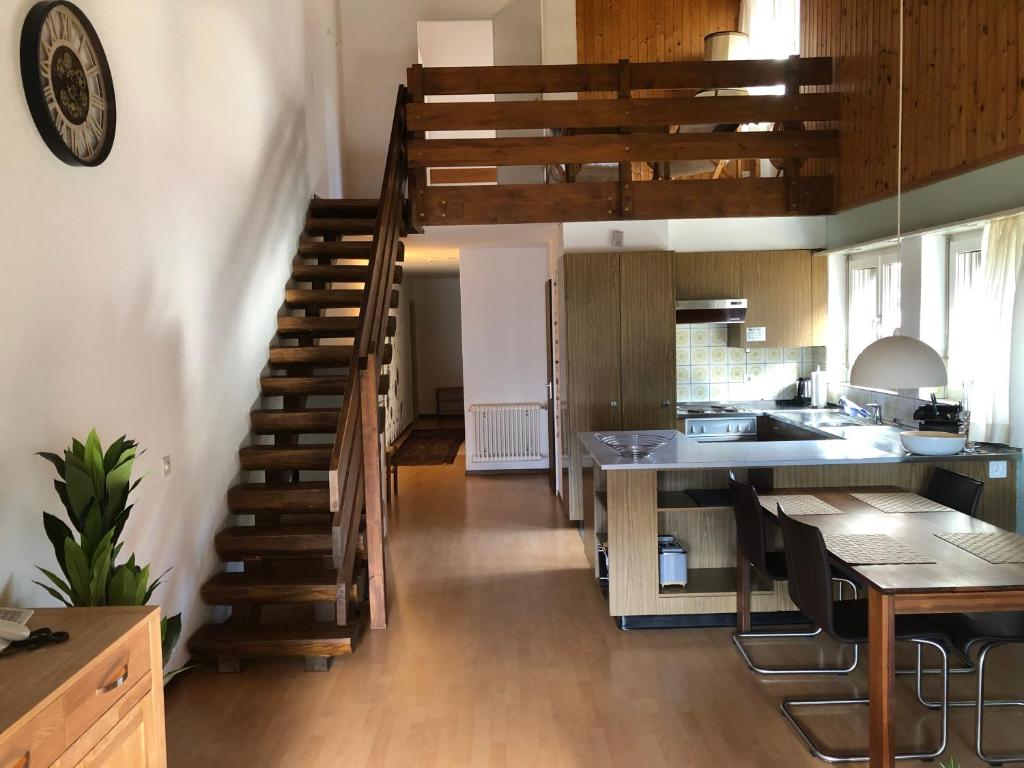 a kitchen with a spiral staircase leading up to a kitchen at Breiten 1 in Mörel