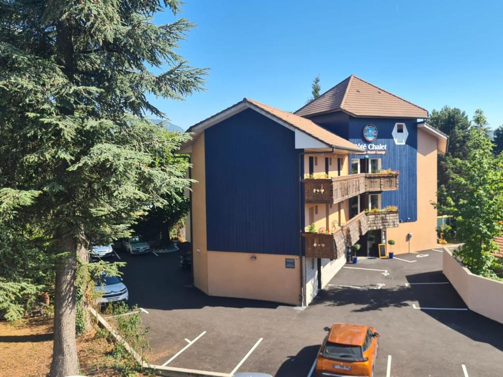 a building with a car parked in a parking lot at Résidence Côté Chalet in Thonon-les-Bains