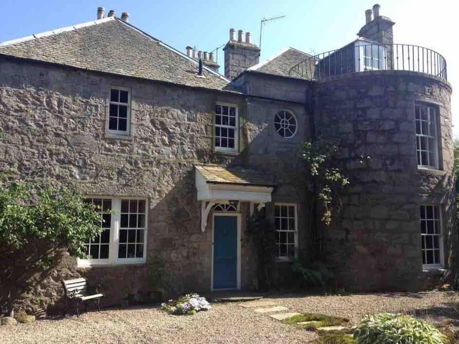 an old stone house with a blue door at 18th Century Manor with Sauna 