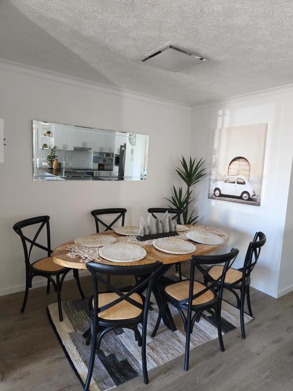 a dining room with a table and chairs at sunrise on the beach in Gold Coast