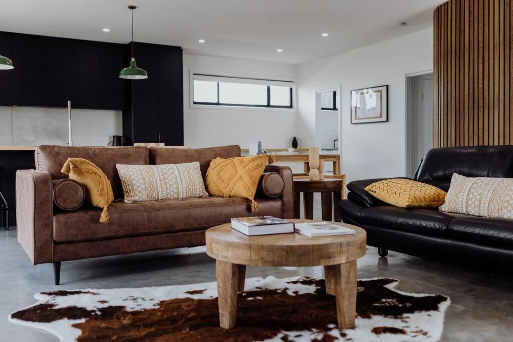 a living room with two couches and a coffee table at Scandi at Stieglitz Sleeps 6 Modern & Stylish in St Helens