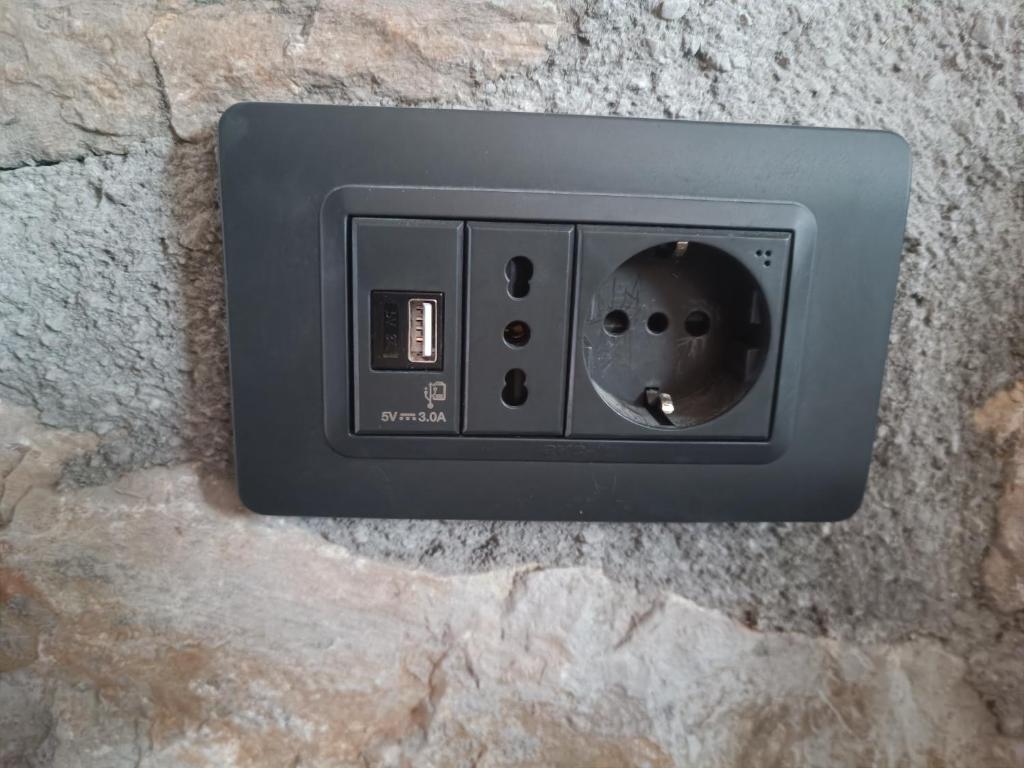 an electrical outlet on a stone wall at Stone House Montenegro in Danilovgrad