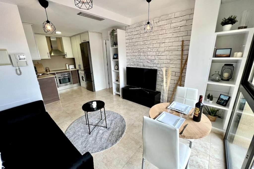 a living room with a table and chairs and a fireplace at Acogedor apartamento entero in Terrassa