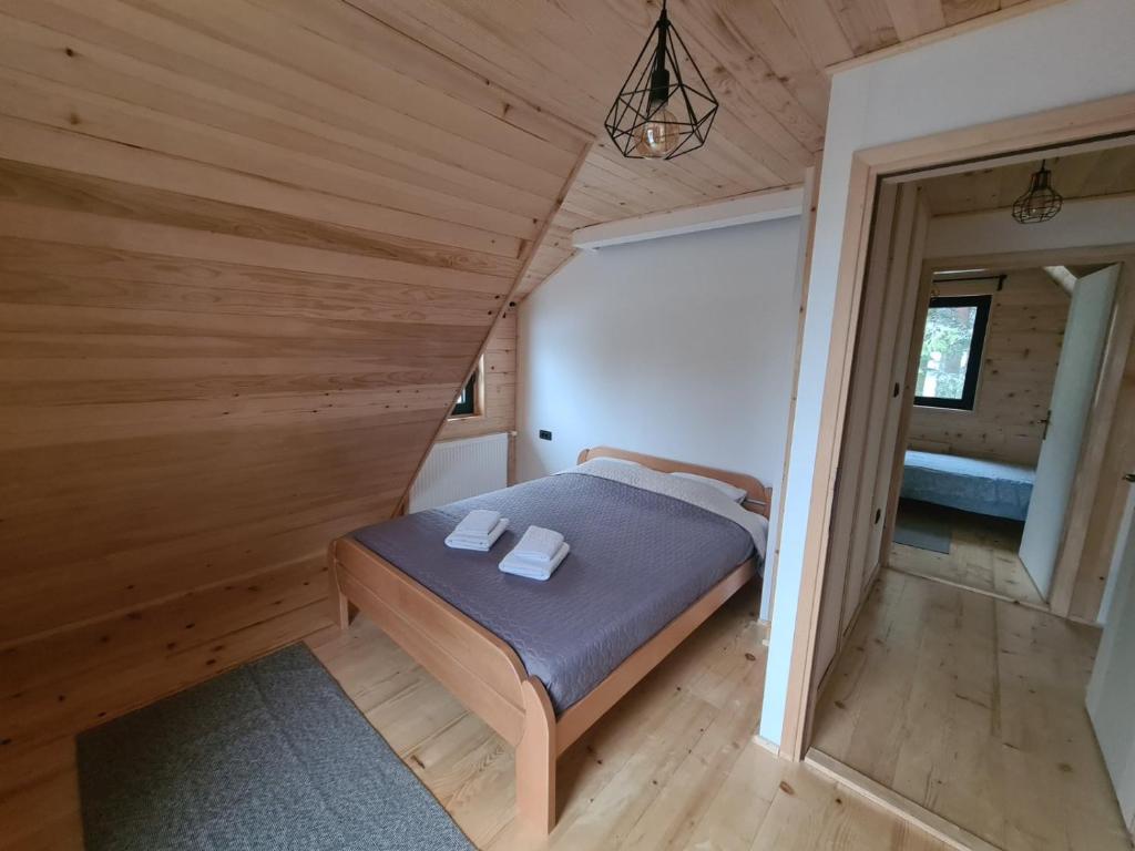 a bedroom in a tiny house with a bed at Vila Dalma in Divčibare