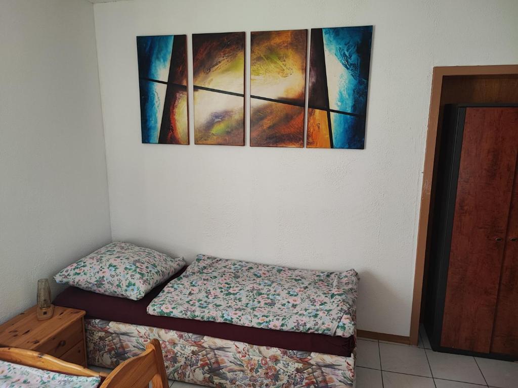 a bedroom with two beds and a painting on the wall at Gästehaus Nachtigall in Gädheim