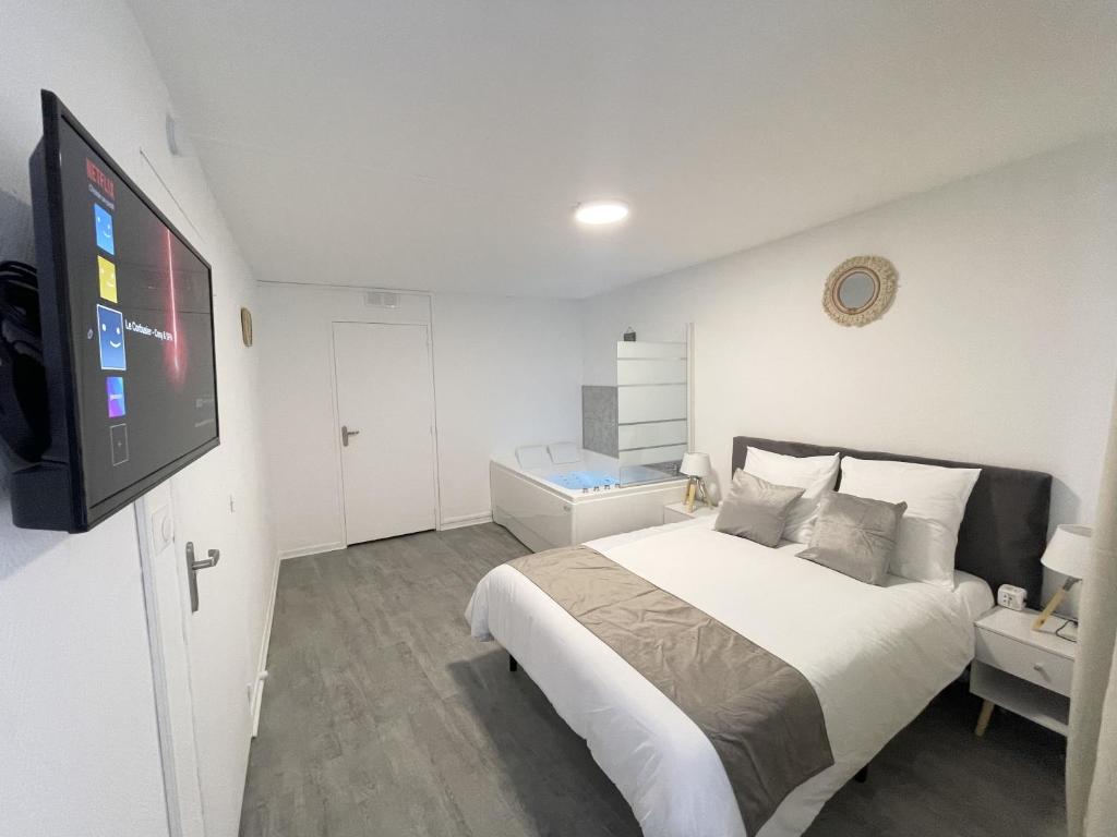 En eller flere senger på et rom på Le Corbusier - Cosy & SPA