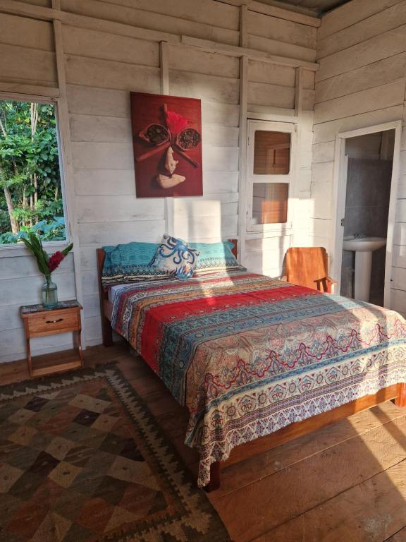 a bedroom with a bed in a room at World's View Wild Camping Salaszoi, Principe Island in Santo António