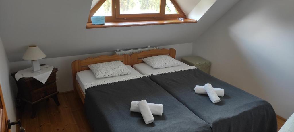 a bedroom with a bed with two crosses on it at Deák Vendégház Dörgicse in Dörgicse