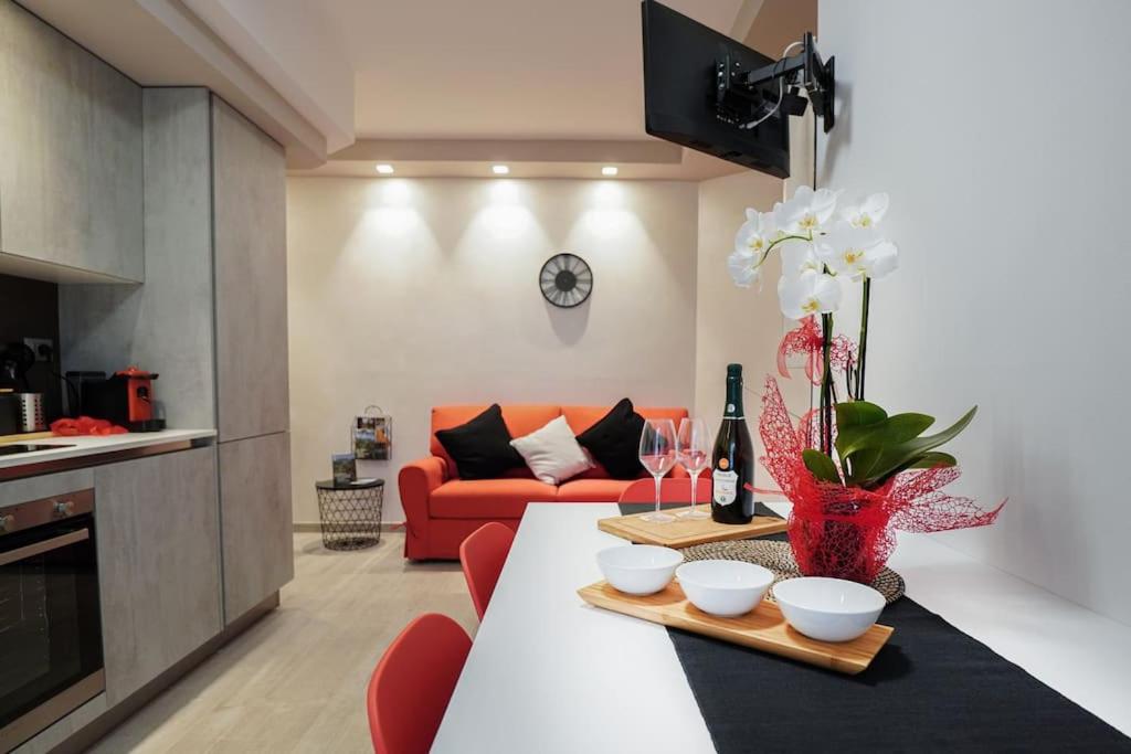 un soggiorno con tavolo e divano rosso di Modern Apartment on the Mt.Baldo & Garda Lake a Brentonico