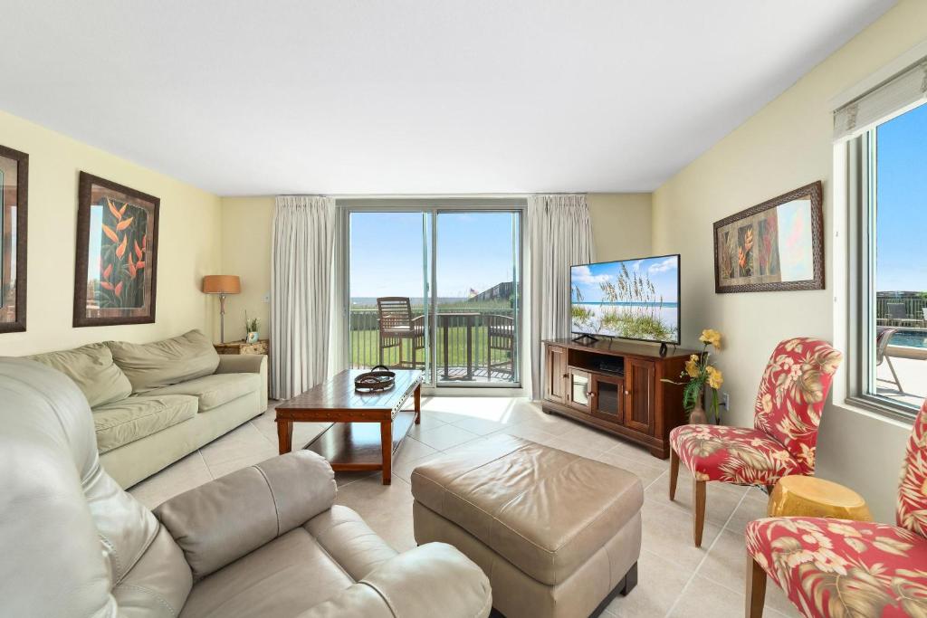 a living room with a couch and a tv at Perdido Towers East 106 in Perdido Key