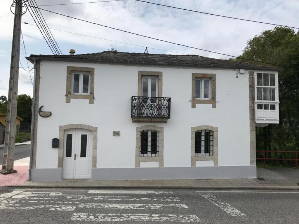 Casa blanca con balcón en una calle en Casa De Don Lino, en Lugo