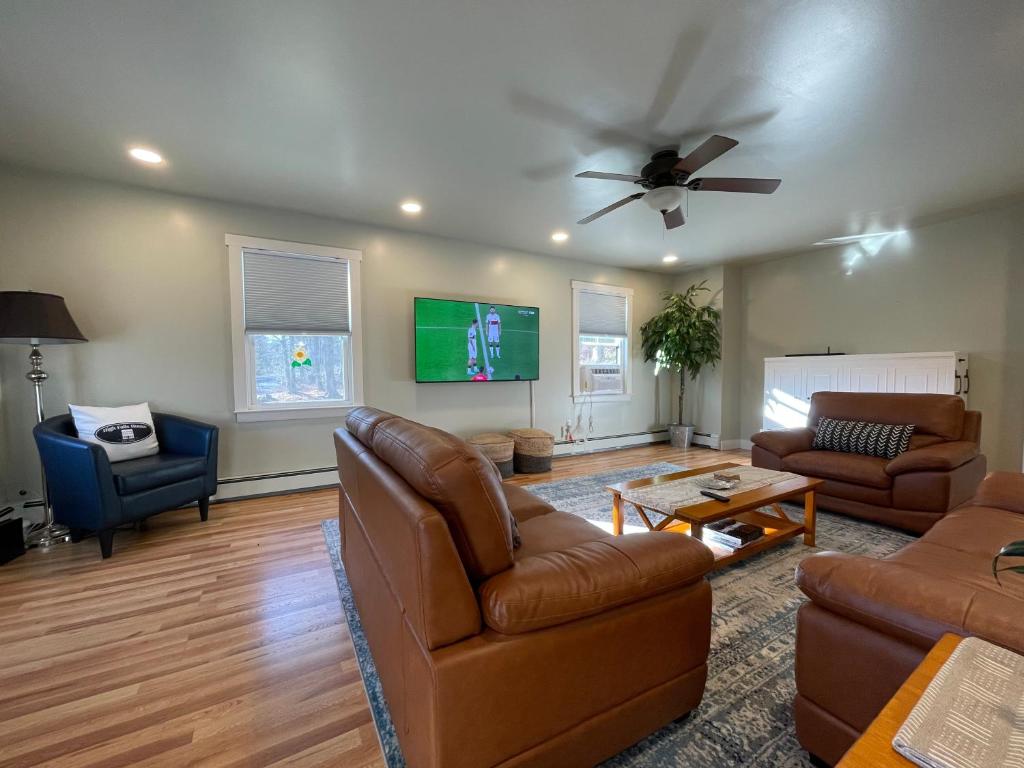 a living room with two couches and a ceiling fan at Catskill home with King bed, indoor hot tub and BBQ near Woodstock and skiing in Saugerties