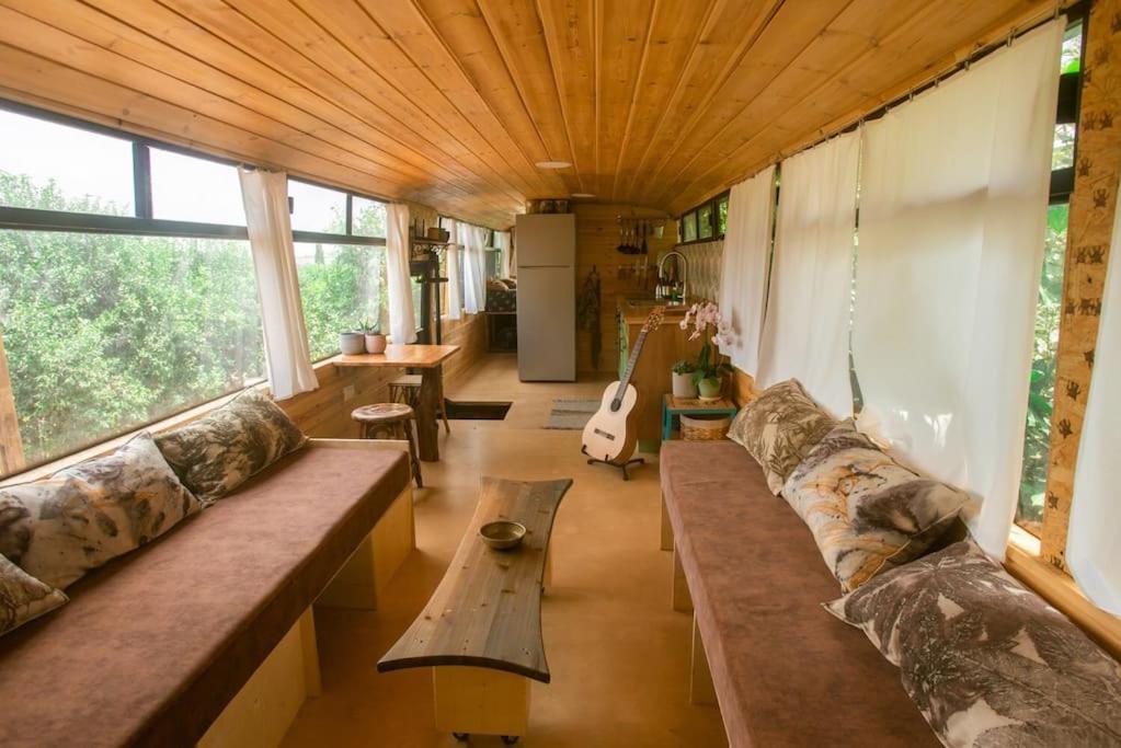 a living room with a couch and a table at Boutique bus in ‘En Sarid