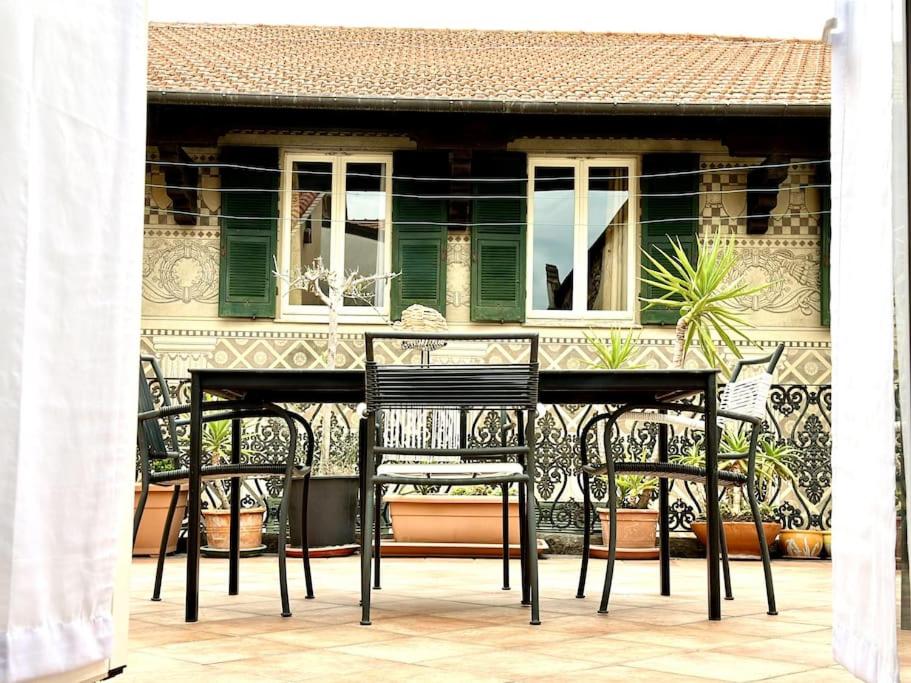 a table and chairs in front of a house at La terrazza sul centro in Albenga