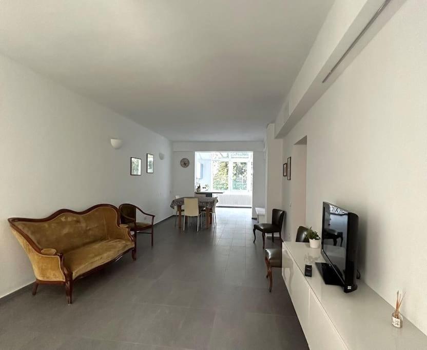 een woonkamer met een bank en een tv bij A casa di Lucio in Budrio