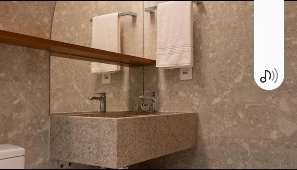 a bathroom with a sink and a mirror at Salinas Premiun Resort Vista Mar ap1604 in Salinópolis
