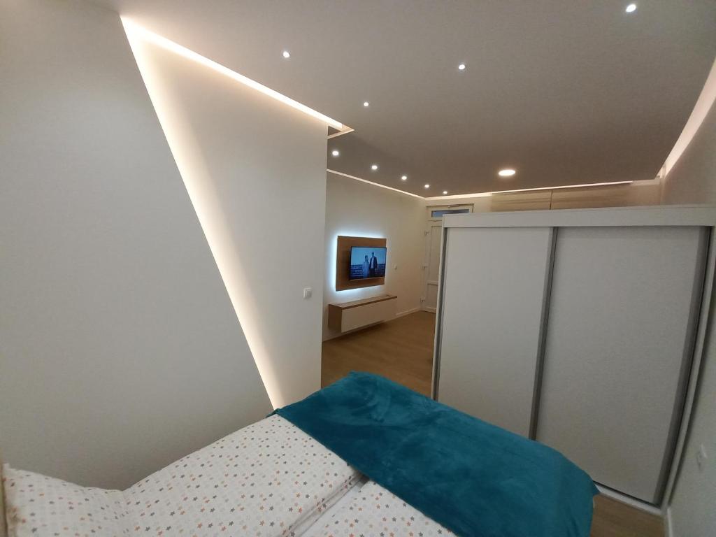 a bedroom with a bed and a tv in a room at Studio Apartman Bambi in Pale