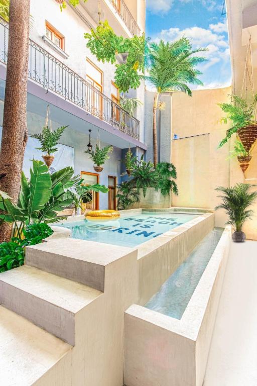 a swimming pool in the middle of a building at AmazINN Places Casco Viejo Pool and Rooftop XIV in Panama City