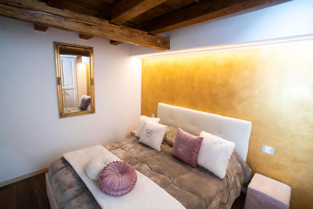 a bedroom with a bed with pillows on it at The Key Of Bergamo in Bergamo