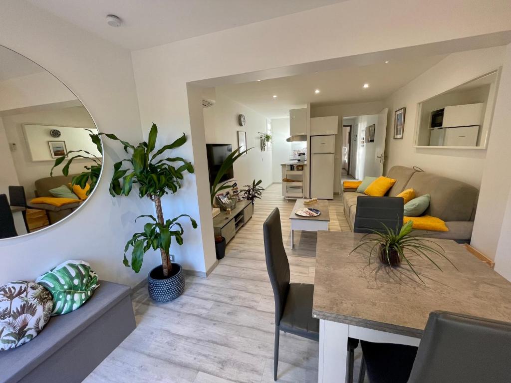 a living room and dining room with a dining table at A1 LA PLAGE D'OR in Le Lavandou