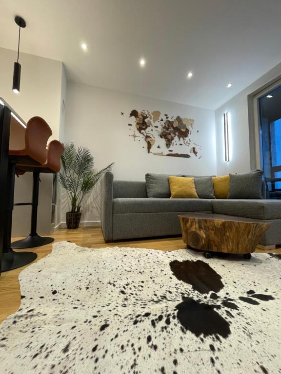 a living room with a couch and a table at Magi - Apartment with balcony in Jahorina