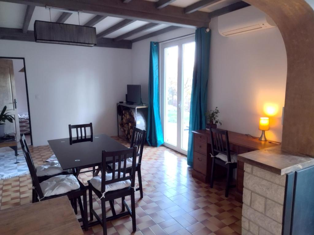 a kitchen and dining room with a table and chairs at La Coste Blanque in Montaut