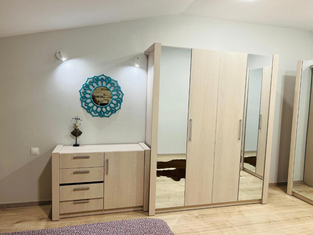 a dressing room with a mirror and a dresser at TOP PROPERTIES AND HOME in Voluntari