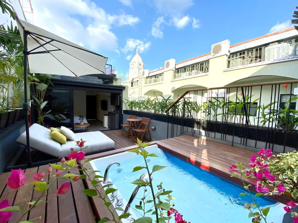 a balcony with a swimming pool on top of a building at AmazINN Places Casco Viejo private Rooftop and Jacuzzi in Panama City