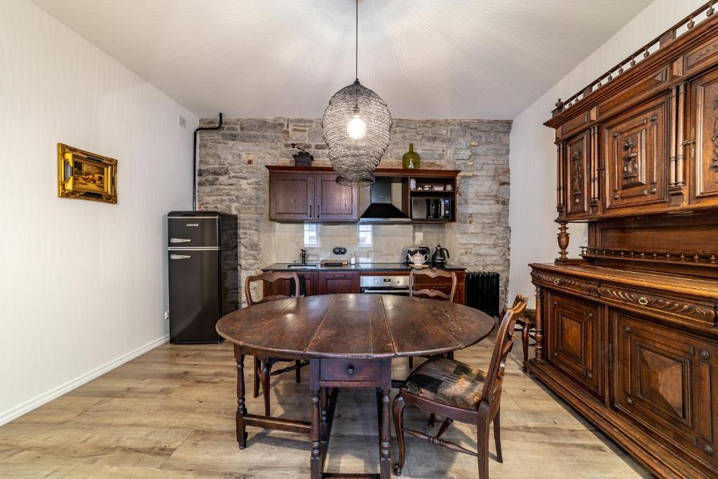 a kitchen with a wooden table in a room at Roofs of the Old Tallinn Guest House in Tallinn