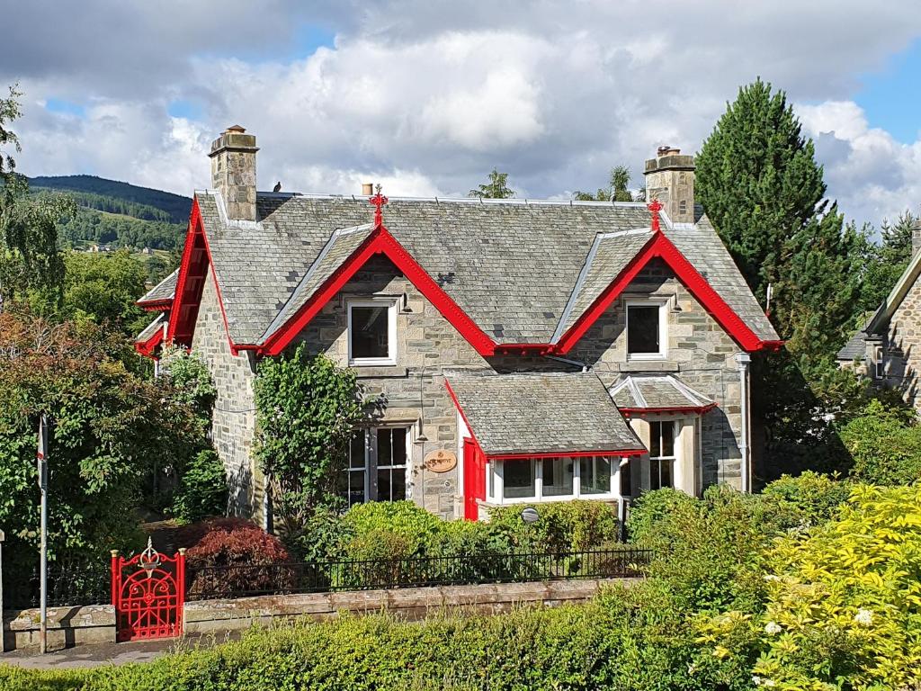 a house with a red roof on top of it at Edengrove in Aberfeldy