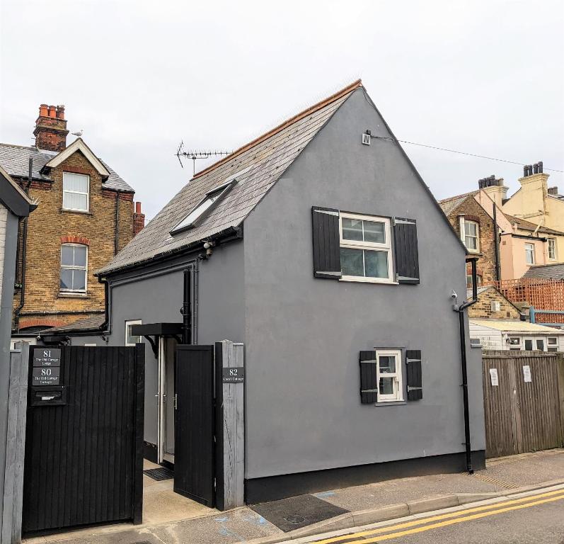 a gray house with a black fence on a street at Cocali Cottage - Stunning, Spacious property close to Deal Beach ! in Walmer