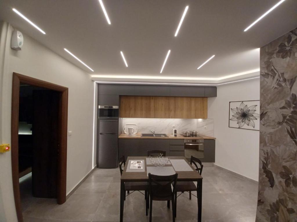 a kitchen with a table and chairs in a room at Top View Apartment in Katerini