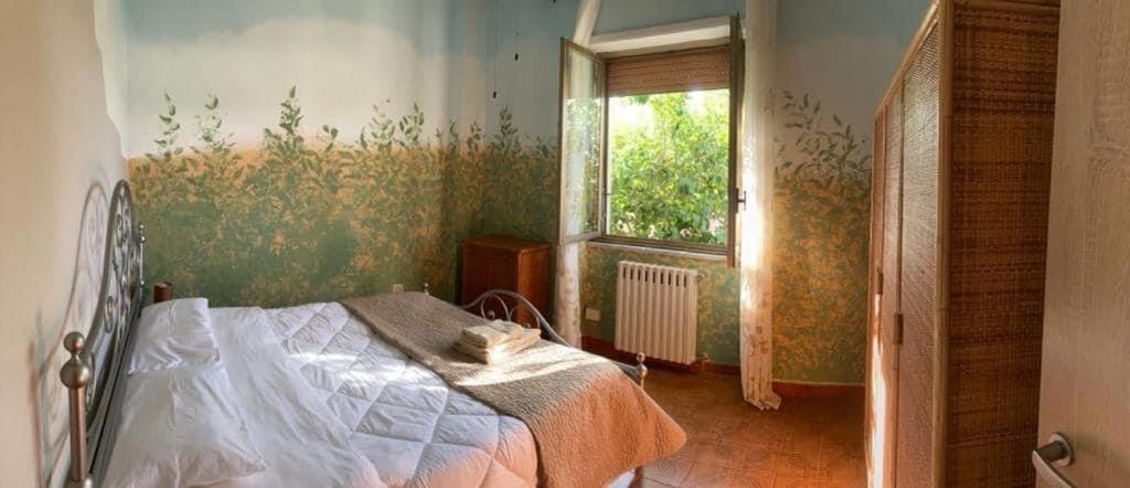 a bedroom with a bed and a window at A Casa Mia in Albano Laziale