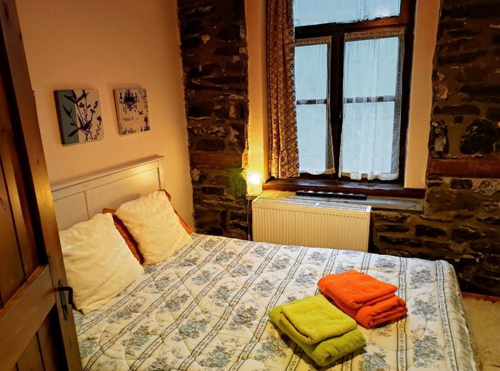 a bedroom with a bed with two towels on it at Cozy Mountain Villa in P. Agios Athanasios in Palaios Agios Athanasios