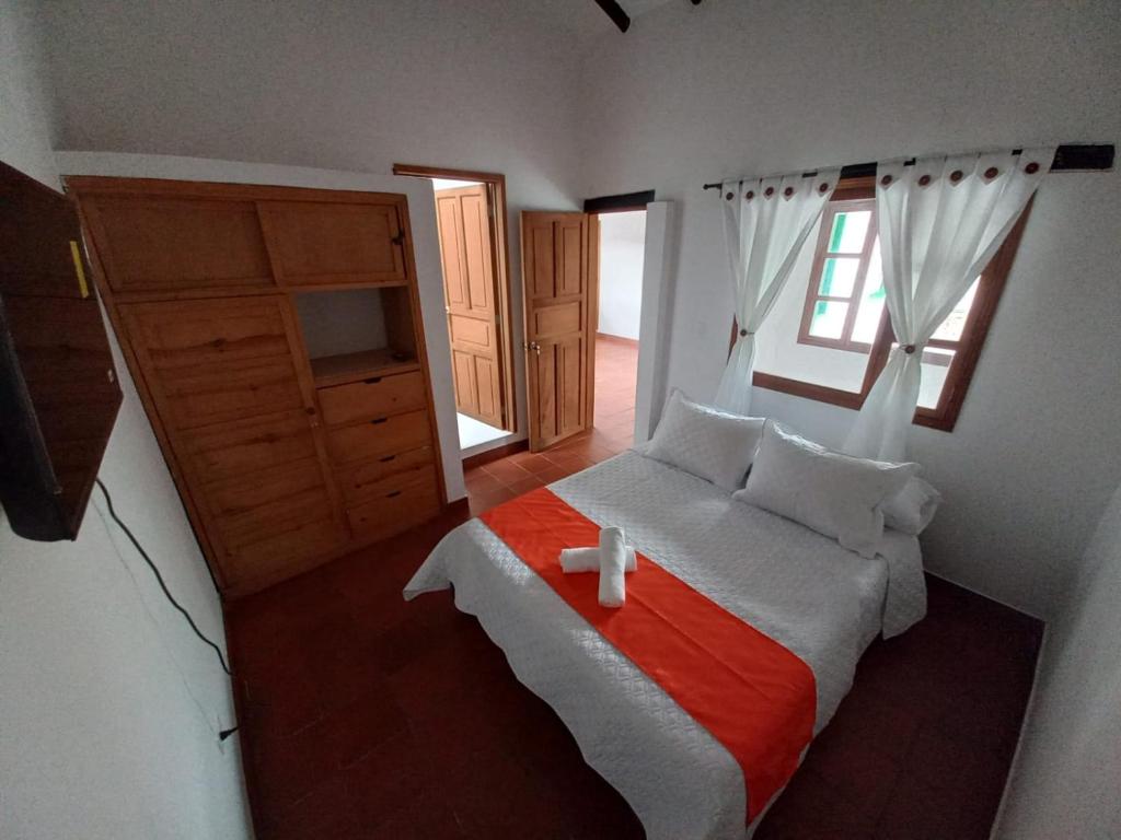 1 dormitorio con cama y ventana en Oasis san José de la villa, en Villa de Leyva