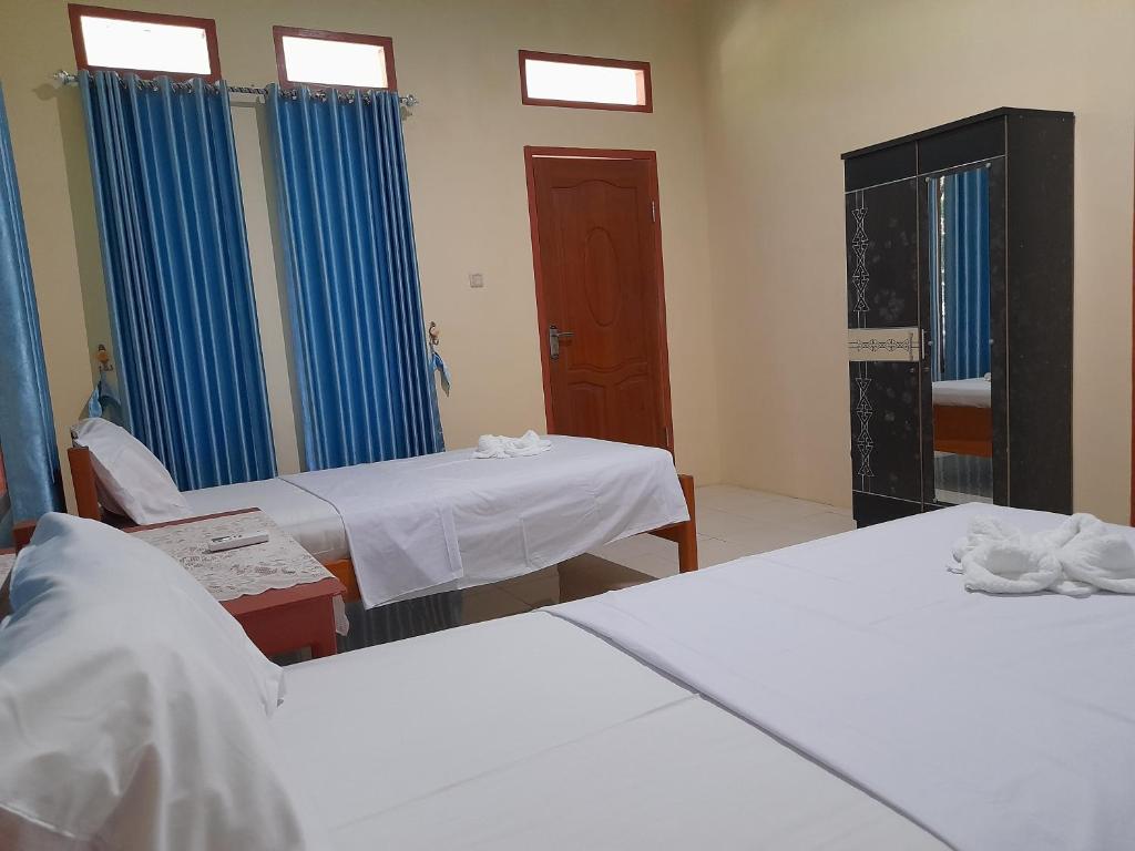 Postel nebo postele na pokoji v ubytování Tangkoko Lodge
