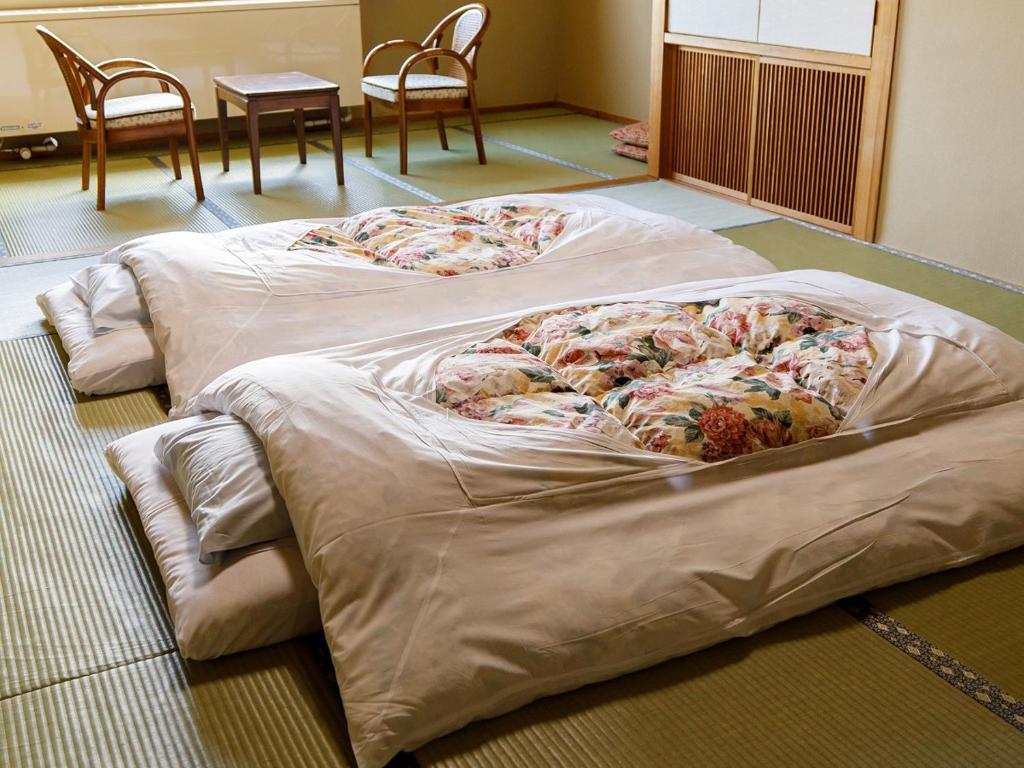 Postel nebo postele na pokoji v ubytování Hotel Iwasuge