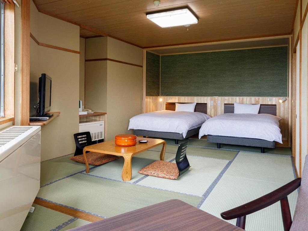Postel nebo postele na pokoji v ubytování Hotel Iwasuge