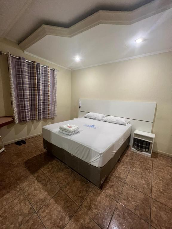 a bedroom with a large bed in a room at Hotel City II in Santo André