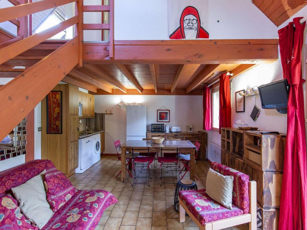 a living room with a dining table and a kitchen at Chalet Cauterets, 4 pièces, 6 personnes - FR-1-401-254 in Cauterets
