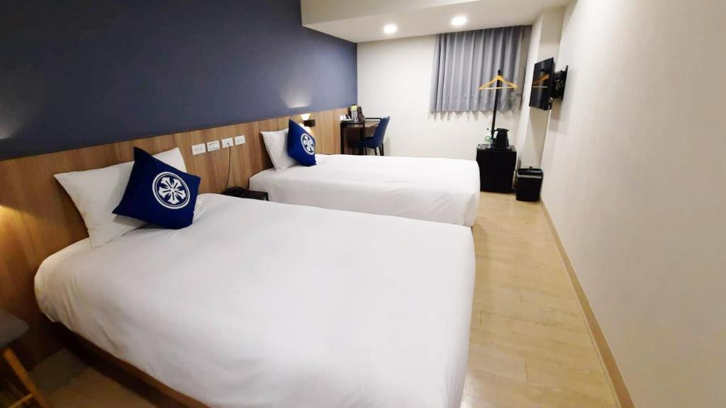 Postel nebo postele na pokoji v ubytování Holo Hotel Tainan