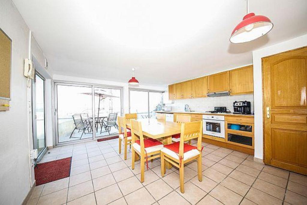 a kitchen with a table and chairs and a dining room at Villa House With Panoramic View On Paris in Suresnes