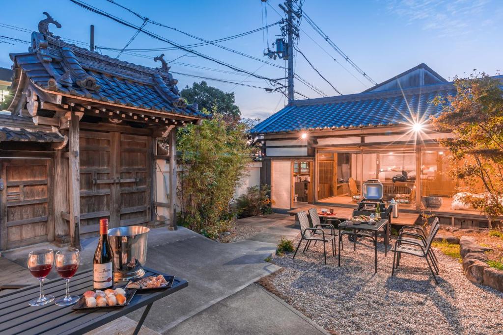 a home with a patio and a table with wine glasses at The temple - Houjuji - in Nara