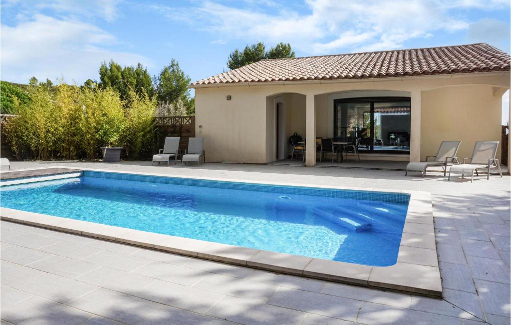a swimming pool in front of a house at 3 Bedroom Cozy Home In Caunes Minervois in Caunes-Minervois