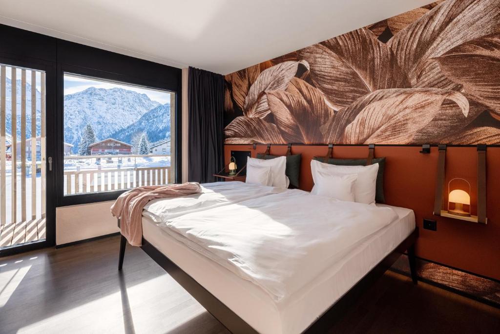a bedroom with a large bed and a large window at Aves Arosa in Arosa