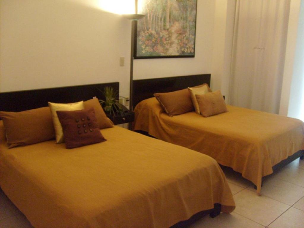 Postel nebo postele na pokoji v ubytování Hotel & Suites Mo Sak