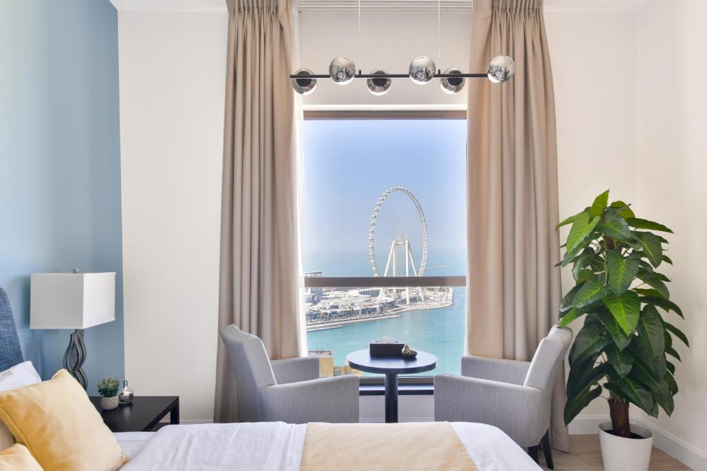 a hotel room with a view of the ferris wheel at Luxury JBR Shams · Full Sea View · Free 5* Beach Resorts Access! in Dubai