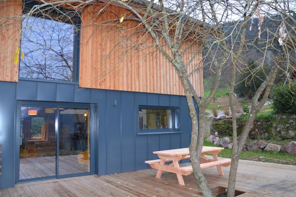 a blue building with a picnic table in front of it at A la cheneau in Rochesson