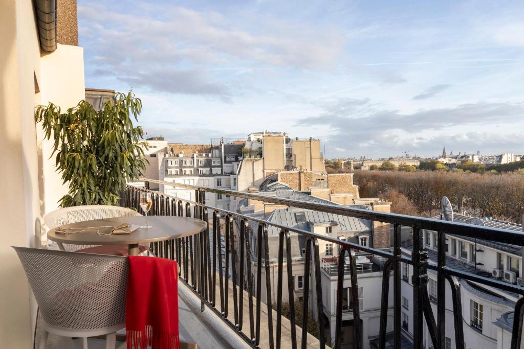 a table and chair on a balcony with a view at Villa Marquis Member of Meliá Collection in Paris