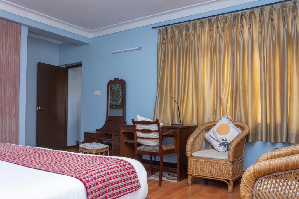 Postel nebo postele na pokoji v ubytování Shaligram Hotel & Spa